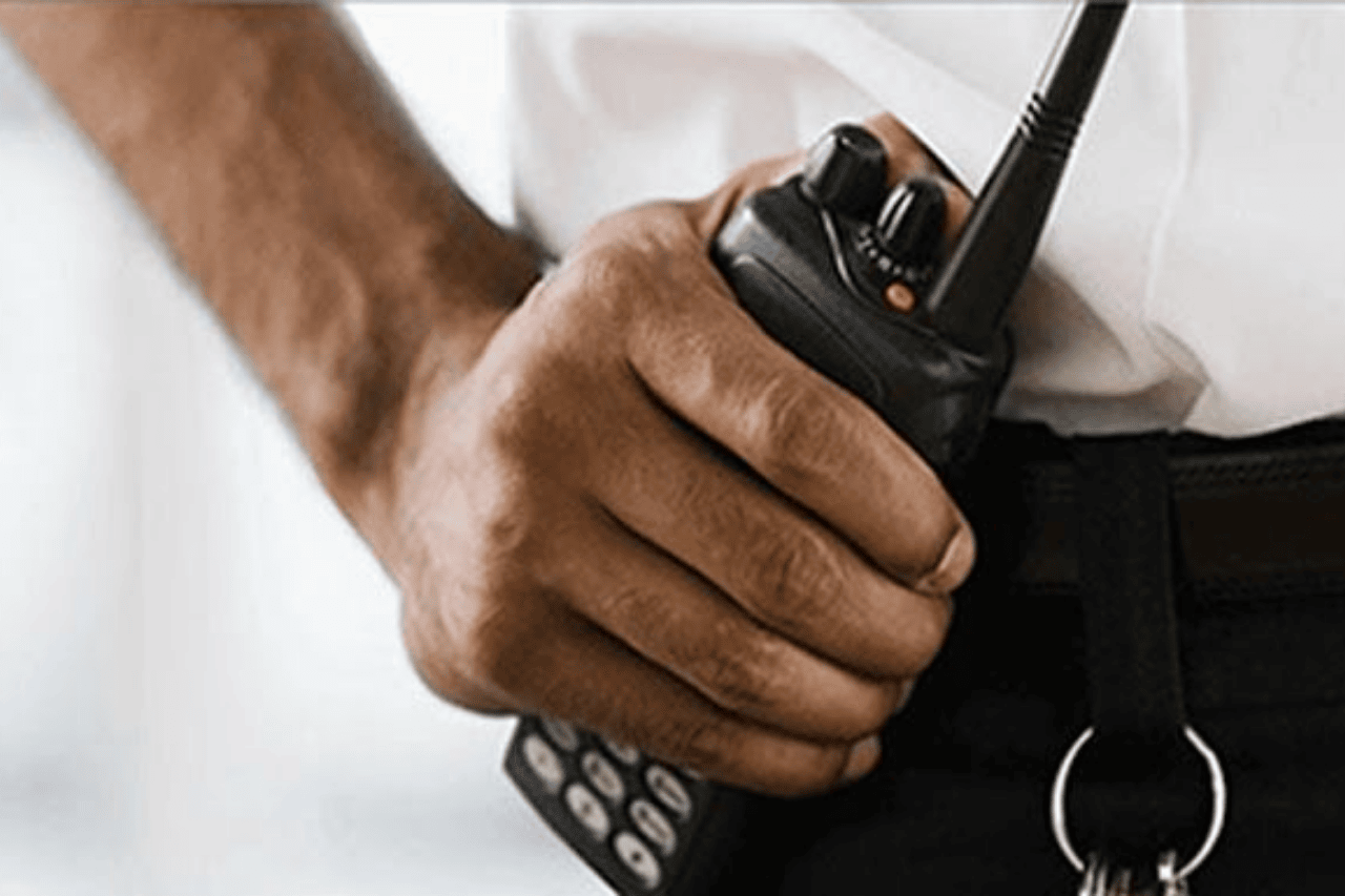 Security team using walkie talkies for shift coordination in Malaysia