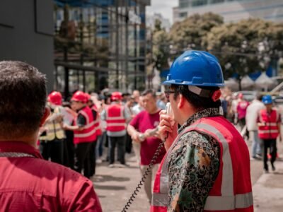 Foreman using a walkie talkie while coordinating construction workers on site