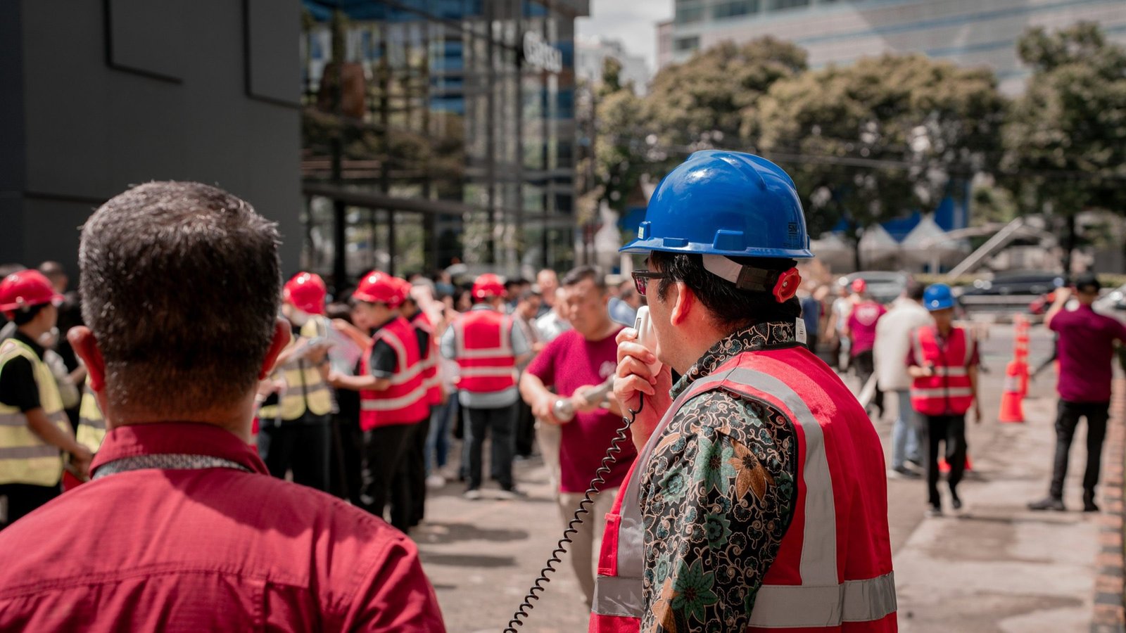 Foreman using a walkie talkie while coordinating construction workers on site