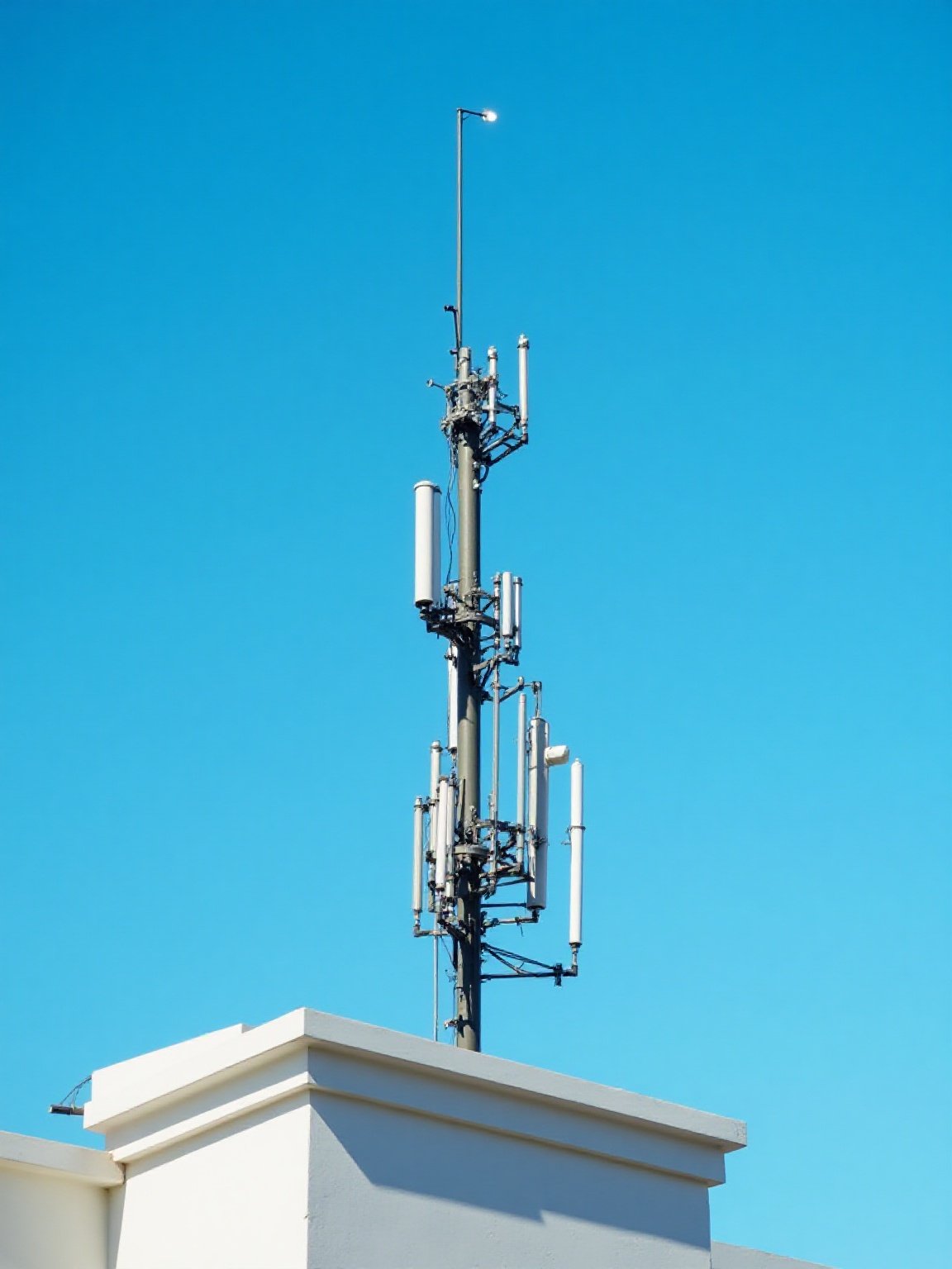 Rooftop antenna mast with directional antennas used to extend two-way radio coverage